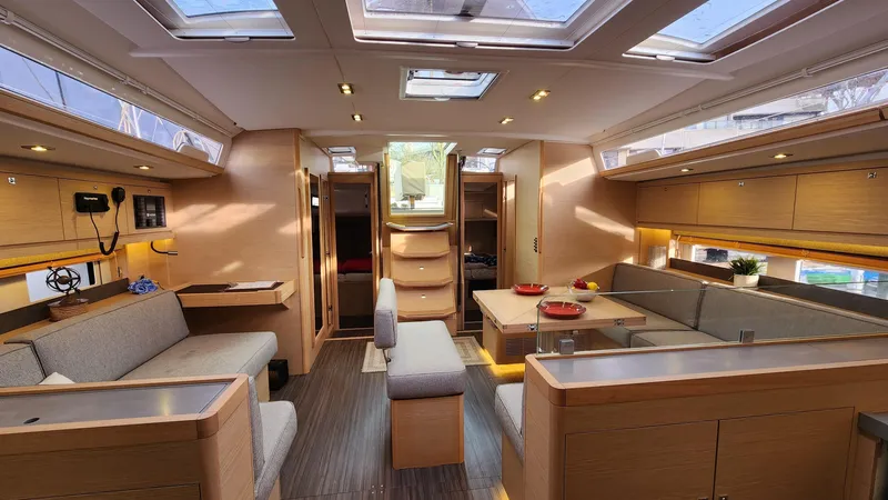 New Stock Boat - Available Now Yacht Photos Pics Luxurious interior of 2023 Dufour 530 yacht with modern furnishings and ample natural light.