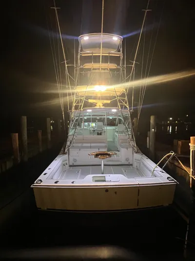  Yacht Photos Pics 2005 Cabo 40 Hardtop Express boat illuminated at night in a marina.