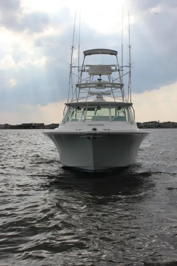 Yacht Photos Pics 2005 Cabo 40 Hardtop Express boat on water under cloudy sky.