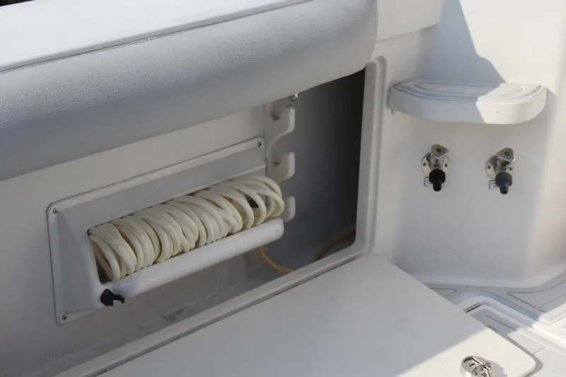  Yacht Photos Pics 2005 Cabo 40 Hardtop Express boat interior with hose storage and control valves.