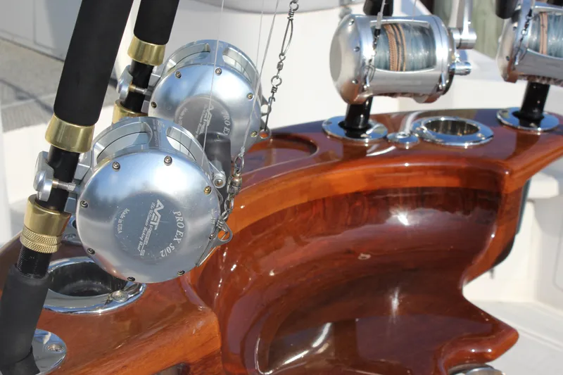  Yacht Photos Pics Fishing rods and reels on a polished wooden holder aboard a 2005 Cabo 40 Hardtop Express.