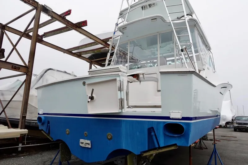  Yacht Photos Pics 2005 Cabo 40 Hardtop Express boat on stands, rear view, in a marina setting.
