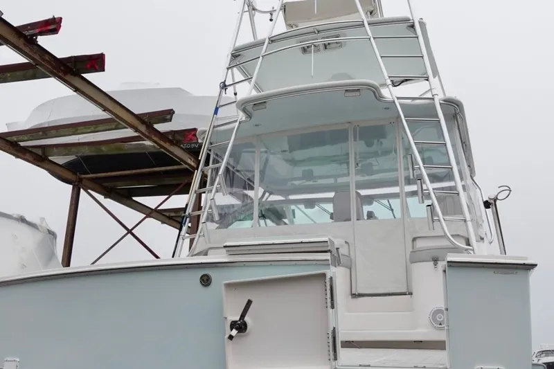 Yacht Photos Pics 2005 Cabo 40 Hardtop Express boat with tower, docked on a foggy day.