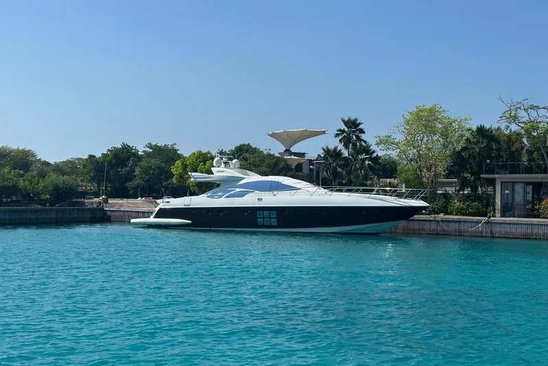 Romeo & Juliet Yacht Photos Pics Luxurious 2009 Azimut 86S yacht docked in serene turquoise waters.