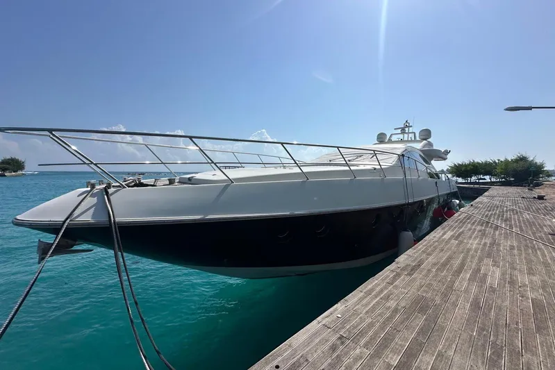 Romeo & Juliet Yacht Photos Pics Luxury 2009 Azimut 86S yacht docked by turquoise waters under clear sky.