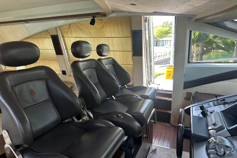 Romeo & Juliet Yacht Photos Pics Interior of 2009 Azimut 86S yacht with luxurious black leather seating and control panel.