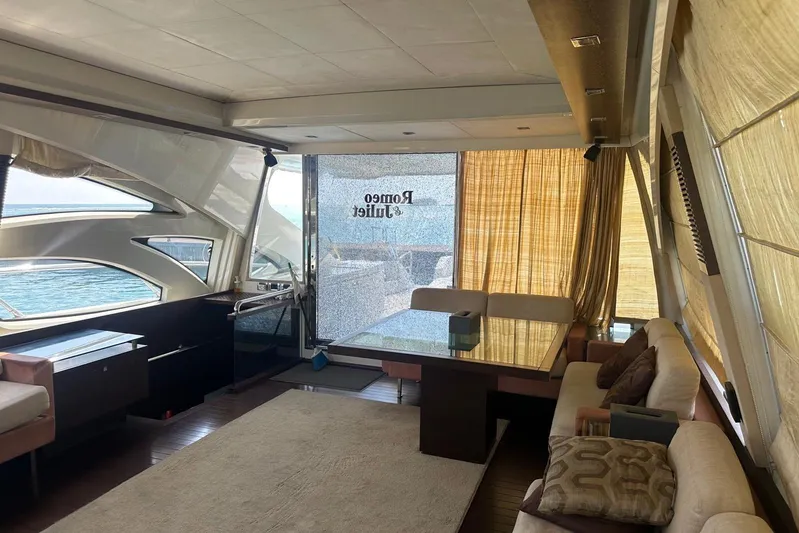 Romeo & Juliet Yacht Photos Pics Luxurious interior of 2009 Azimut 86S yacht with elegant seating and panoramic windows.