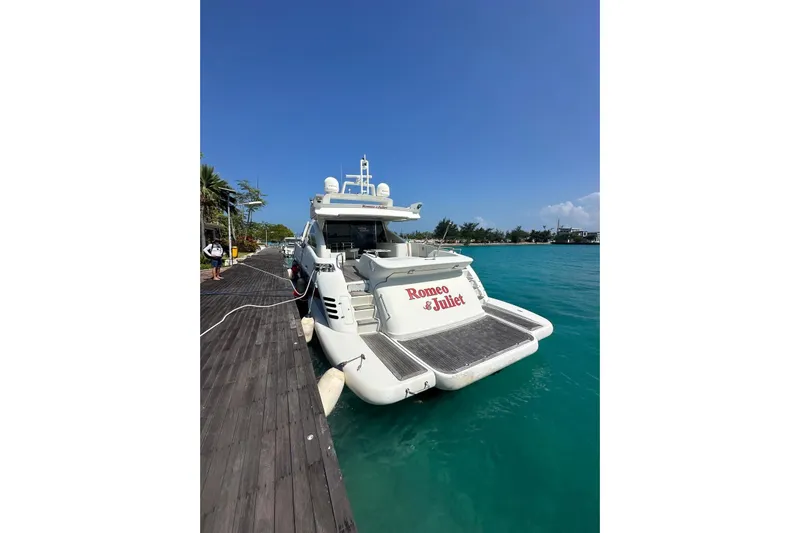 Romeo & Juliet Yacht Photos Pics Luxury 2009 Azimut 86S yacht docked, named "Romeo & Juliet," in clear blue waters.