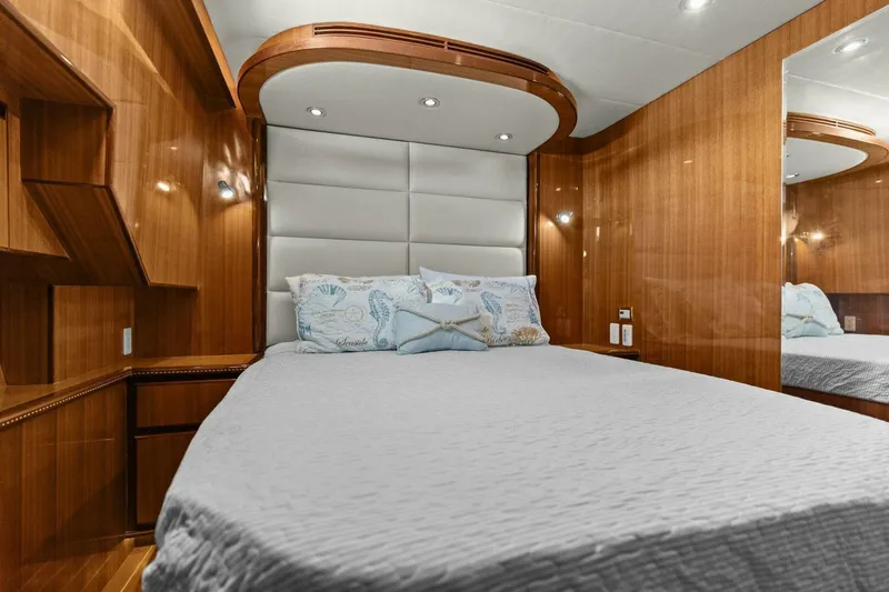 Sunshine And Happiness Yacht Photos Pics Luxurious yacht bedroom with wood paneling, plush bedding, and modern lighting.