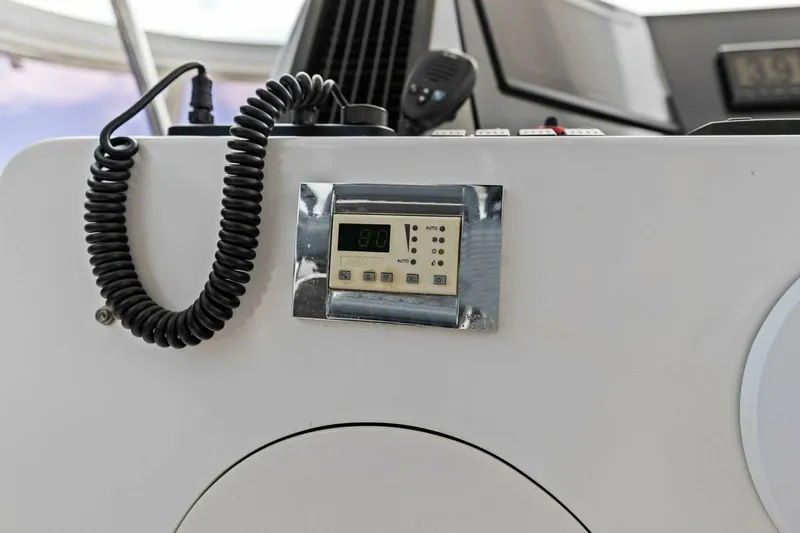 Sunshine And Happiness Yacht Photos Pics Control panel with coiled cable on a white surface, possibly in a vehicle or boat.