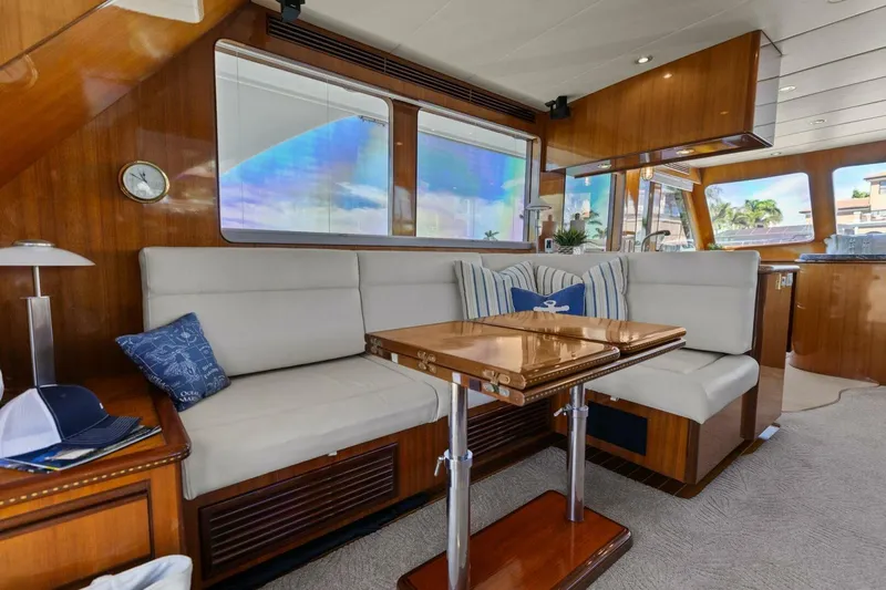 Sunshine And Happiness Yacht Photos Pics Luxurious yacht interior with plush seating and wooden table, featuring nautical decor.