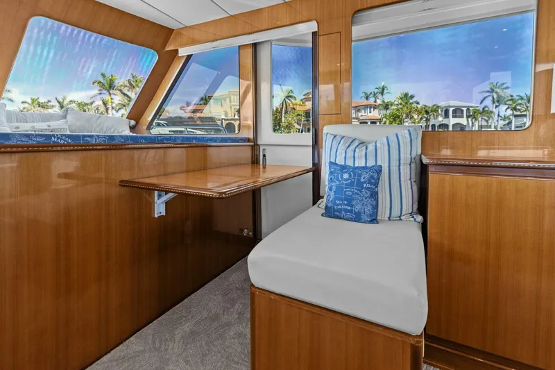 Sunshine And Happiness Yacht Photos Pics Luxurious yacht interior with wooden finish, cushioned seating, and scenic window views.