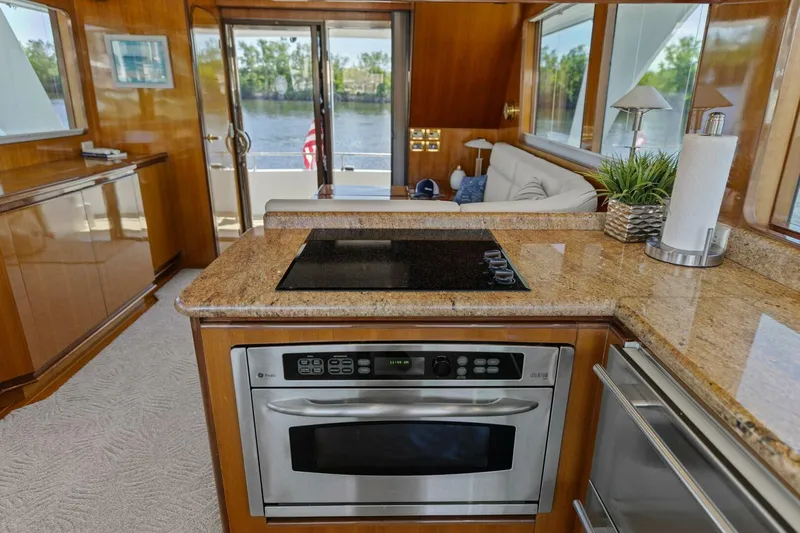 Sunshine And Happiness Yacht Photos Pics Luxurious yacht interior with modern kitchen, granite countertops, and scenic water view.