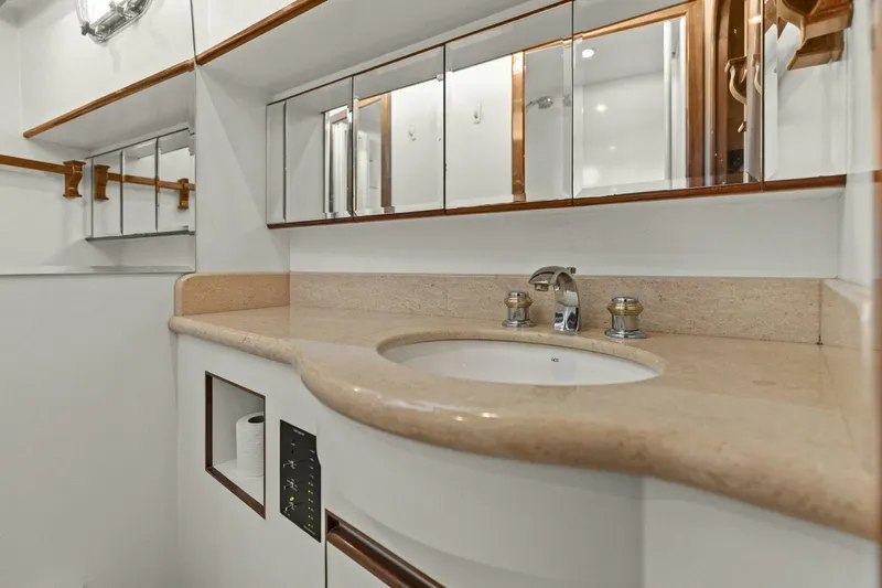 Sunshine And Happiness Yacht Photos Pics Modern bathroom vanity with beige countertop and mirrored cabinets.