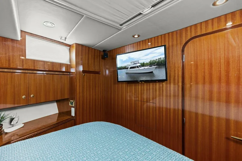 Sunshine And Happiness Yacht Photos Pics Luxurious yacht cabin with wood paneling and wall-mounted TV.
