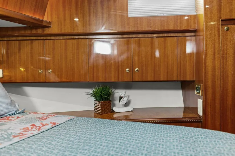 Sunshine And Happiness Yacht Photos Pics Luxurious wooden cabin interior with bed, decorative plant, and elegant furnishings.