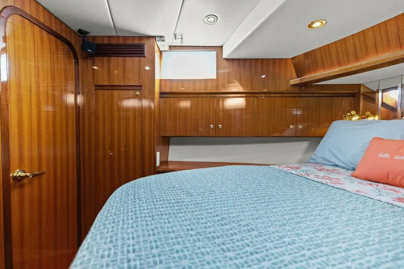 Sunshine And Happiness Yacht Photos Pics Luxurious yacht cabin with wooden paneling and a cozy bed.