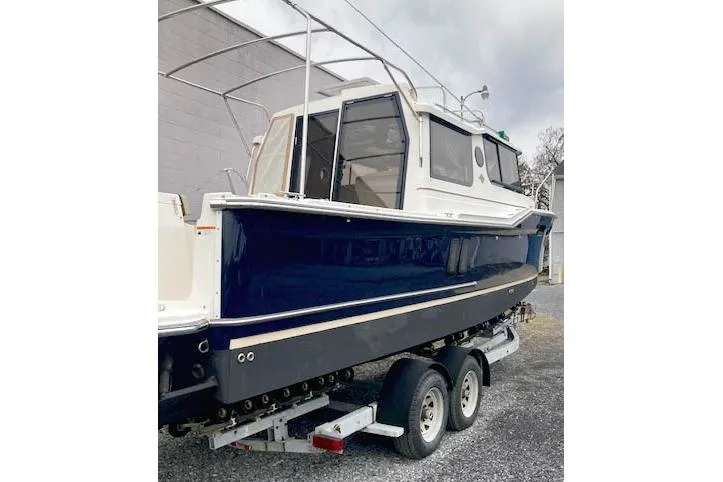  Yacht Photos Pics 2018 Ranger Tugs R-27 boat on trailer, blue hull, parked outdoors.