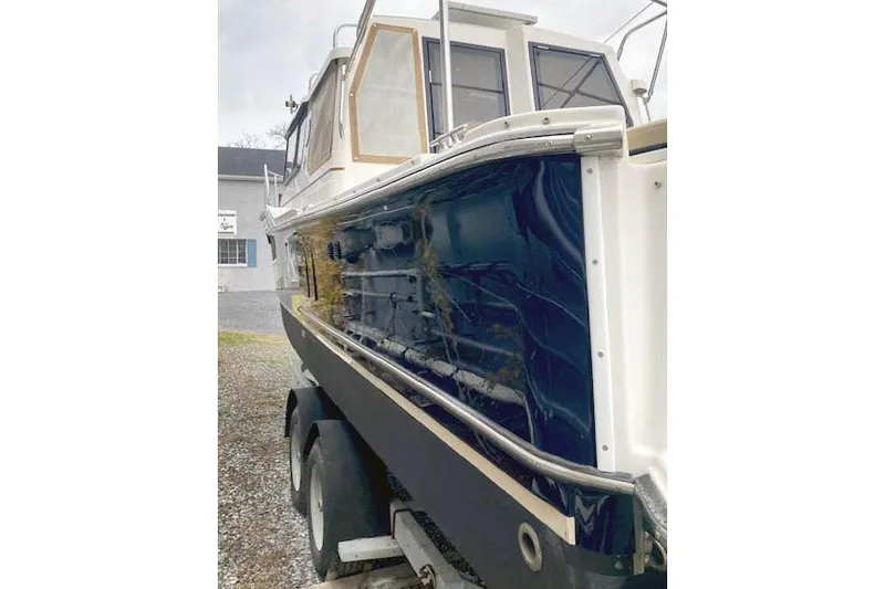  Yacht Photos Pics 2018 Ranger Tugs R-27 boat on trailer, featuring sleek blue and white design.