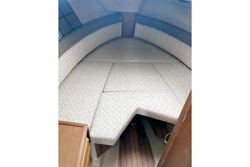  Yacht Photos Pics 2018 Ranger Tugs R-27 cabin interior with patterned cushions and wooden flooring.