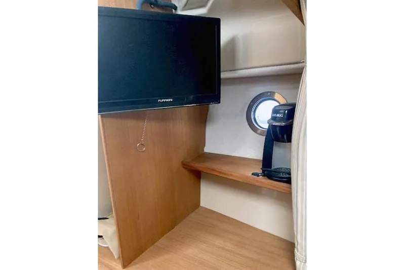  Yacht Photos Pics 2018 Ranger Tugs R-27 interior with TV, porthole, and coffee maker.