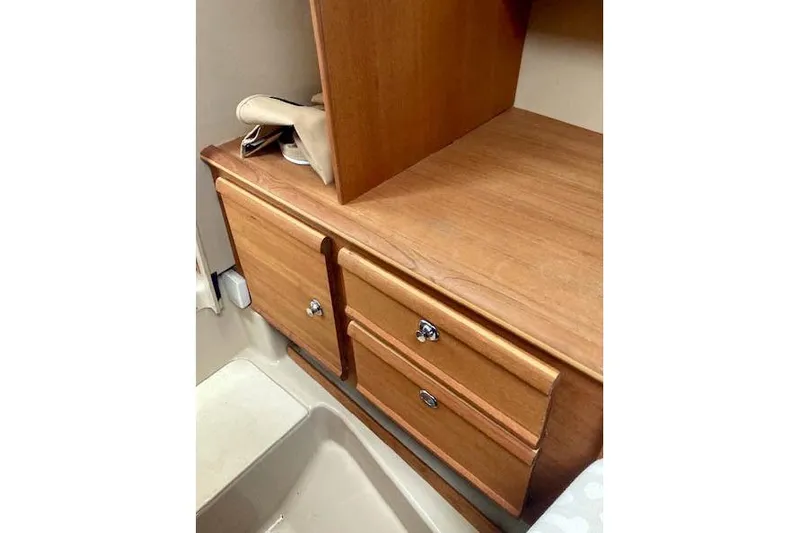  Yacht Photos Pics 2018 Ranger Tugs R-27 interior with wooden cabinetry and storage drawers.