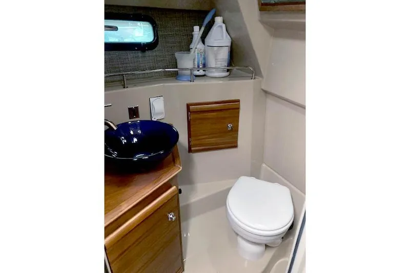  Yacht Photos Pics 2018 Ranger Tugs R-27 boat bathroom with toilet, sink, and storage cabinet.