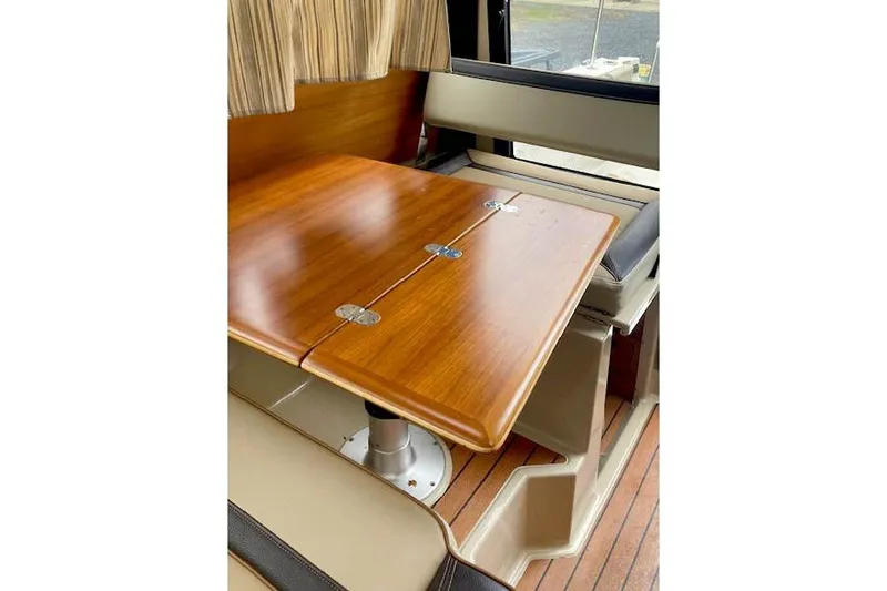  Yacht Photos Pics Interior of 2018 Ranger Tugs R-27 with wooden table and seating area.