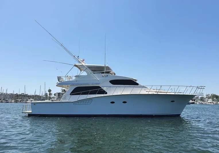 Patrona Yacht Photos Pics 2000 Mikelson 61 Sportfisher yacht on calm water under clear blue sky.