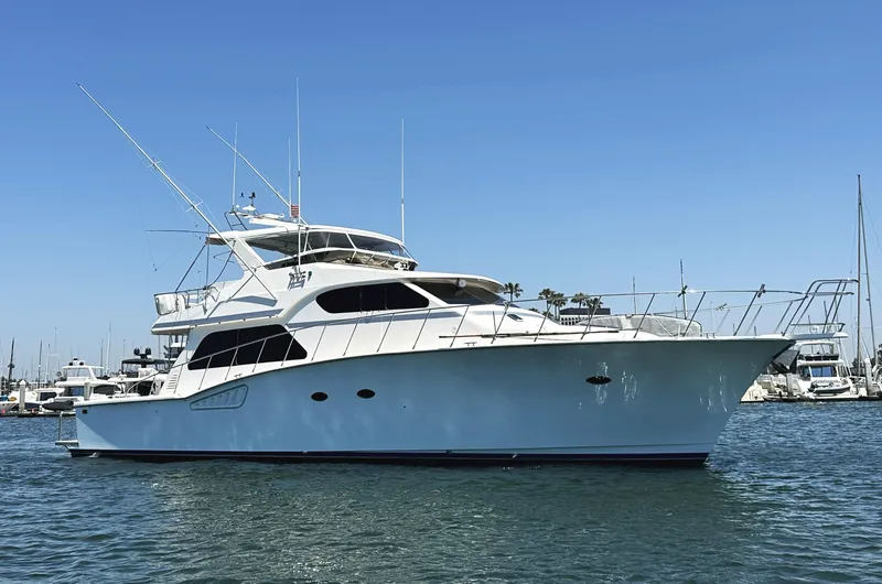 Patrona Yacht Photos Pics Mikelson 61 Sportfisher 2000 yacht on calm water, clear sky background.