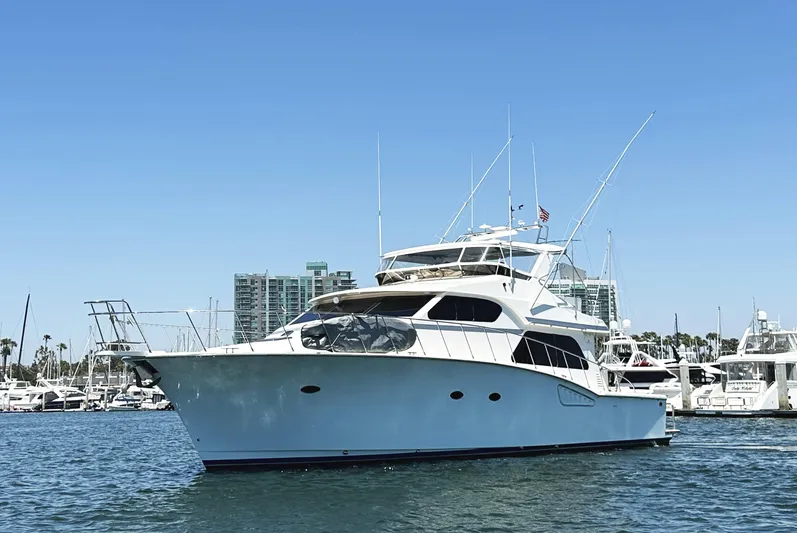 Patrona Yacht Photos Pics Mikelson 61 Sportfisher 2000 yacht on water, clear sky, marina background.