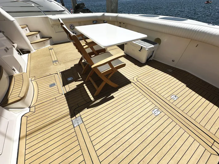 Patrona Yacht Photos Pics Spacious deck of 2000 Mikelson 61 Sportfisher with wooden flooring and seating area.