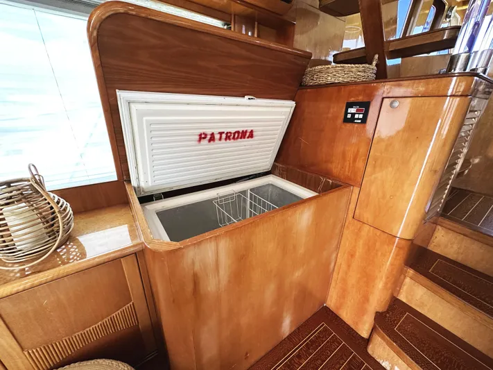 Patrona Yacht Photos Pics Open freezer on 2000 Mikelson 61 Sportfisher yacht, wooden interior, labeled "Patrona".
