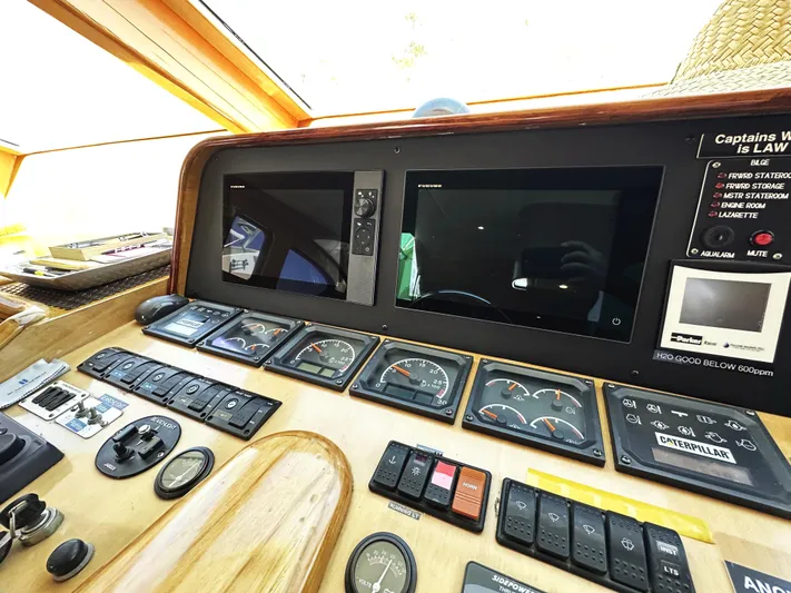 Patrona Yacht Photos Pics Control panel of a 2000 Mikelson 61 Sportfisher boat with gauges and screens.