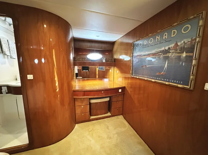 Patrona Yacht Photos Pics Luxurious interior of 2000 Mikelson 61 Sportfisher yacht with wood paneling and Coronado artwork.