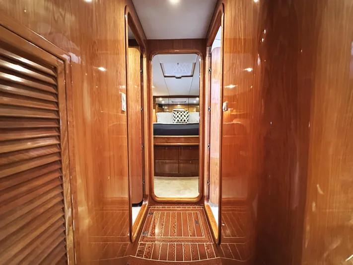 Patrona Yacht Photos Pics Luxurious wooden interior of a 2000 Mikelson 61 Sportfisher yacht cabin hallway.