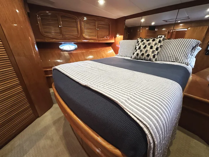 Patrona Yacht Photos Pics Luxurious cabin interior of a 2000 Mikelson 61 Sportfisher yacht with elegant bedding.