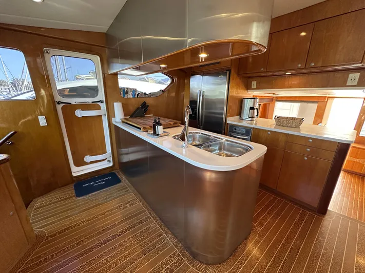 Patrona Yacht Photos Pics Luxurious kitchen interior of 2000 Mikelson 61 Sportfisher yacht with modern amenities.