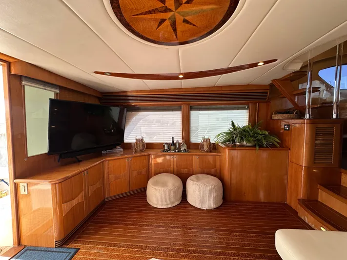 Patrona Yacht Photos Pics Luxurious interior of 2000 Mikelson 61 Sportfisher yacht with wood paneling and modern amenities.