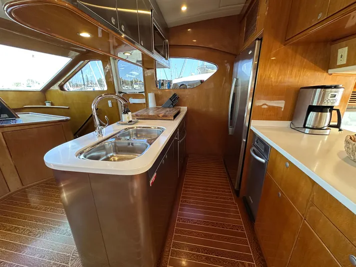 Patrona Yacht Photos Pics Luxurious kitchen interior of 2000 Mikelson 61 Sportfisher yacht with modern appliances.