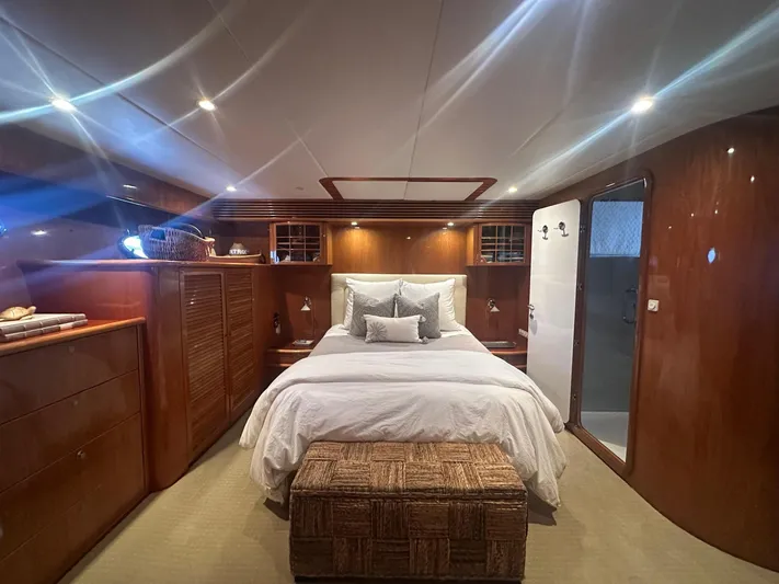 Patrona Yacht Photos Pics Luxurious cabin interior of 2000 Mikelson 61 Sportfisher yacht with elegant wood finishes.