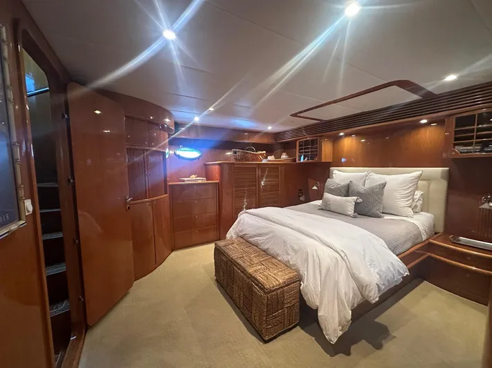 Patrona Yacht Photos Pics Luxurious bedroom interior of 2000 Mikelson 61 Sportfisher yacht with elegant wood finishes.