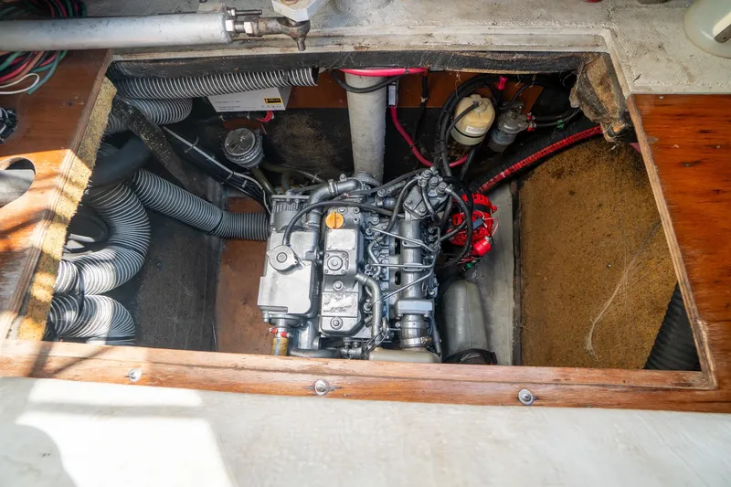  Yacht Photos Pics Engine compartment of a 2009 Lagoon 420 catamaran, showcasing mechanical components and wiring.