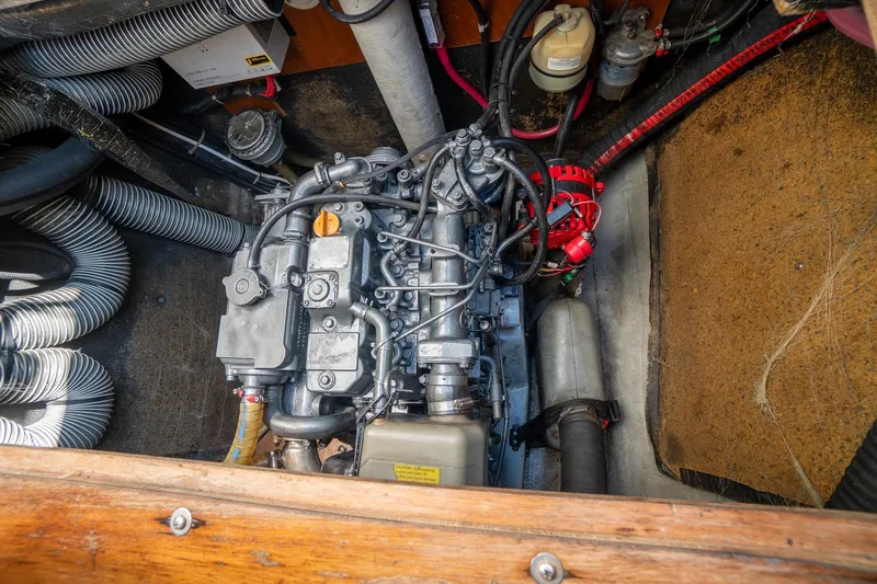  Yacht Photos Pics Engine compartment of a 2009 Lagoon 420 catamaran, showcasing mechanical components and hoses.