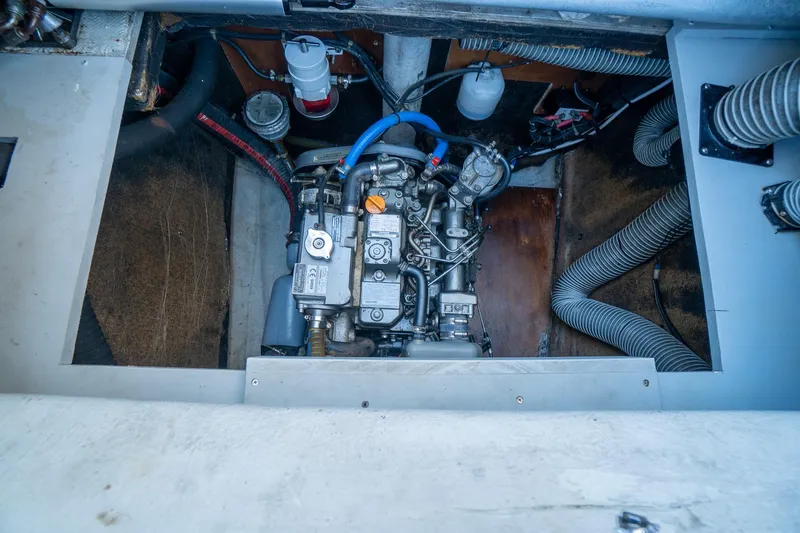  Yacht Photos Pics Engine compartment of a 2009 Lagoon 420 catamaran, showcasing mechanical components and hoses.