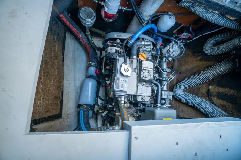  Yacht Photos Pics Engine compartment of a 2009 Lagoon 420 yacht, showcasing mechanical components and hoses.