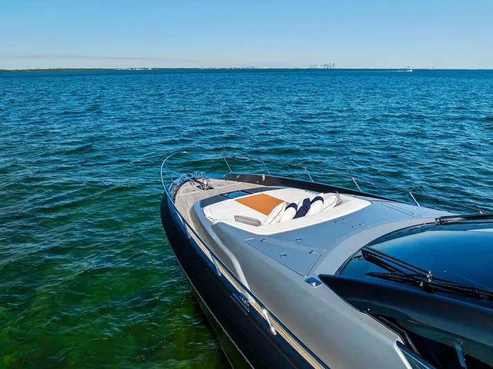 Arcadia Yacht Photos Pics 2020 Riva 66' Ribelle yacht on open sea, sleek design, sunny day.