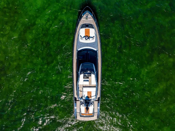 Arcadia Yacht Photos Pics Aerial view of 2020 Riva 66' Ribelle yacht on green water.