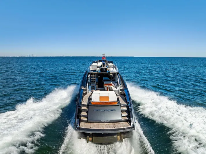 Arcadia Yacht Photos Pics Riva 66' Ribelle 2020 yacht cruising on open sea, rear view.