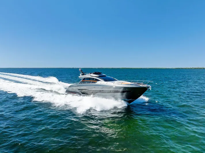 Arcadia Yacht Photos Pics 2020 Riva 66' Ribelle yacht cruising on open water under clear blue sky.